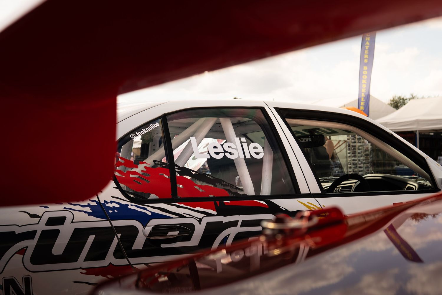 Close-up of a white racing car door with Leslie name decal and Prime sponsorship livery.