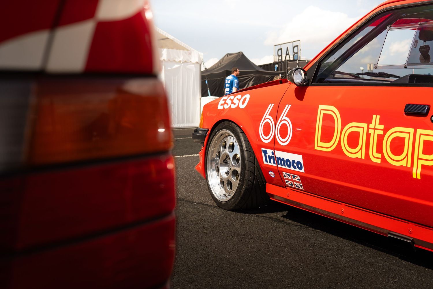 Red Datapart number 66 vintage racing car with Esso and Trimoco sponsorship at a motorsport event.