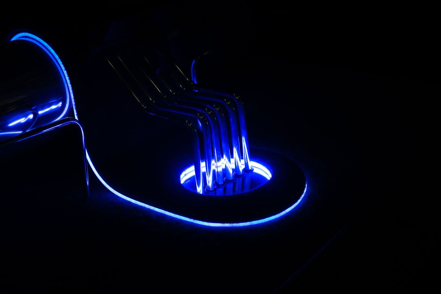 Blue LED neon light illuminating a custom car interior detail in the dark.