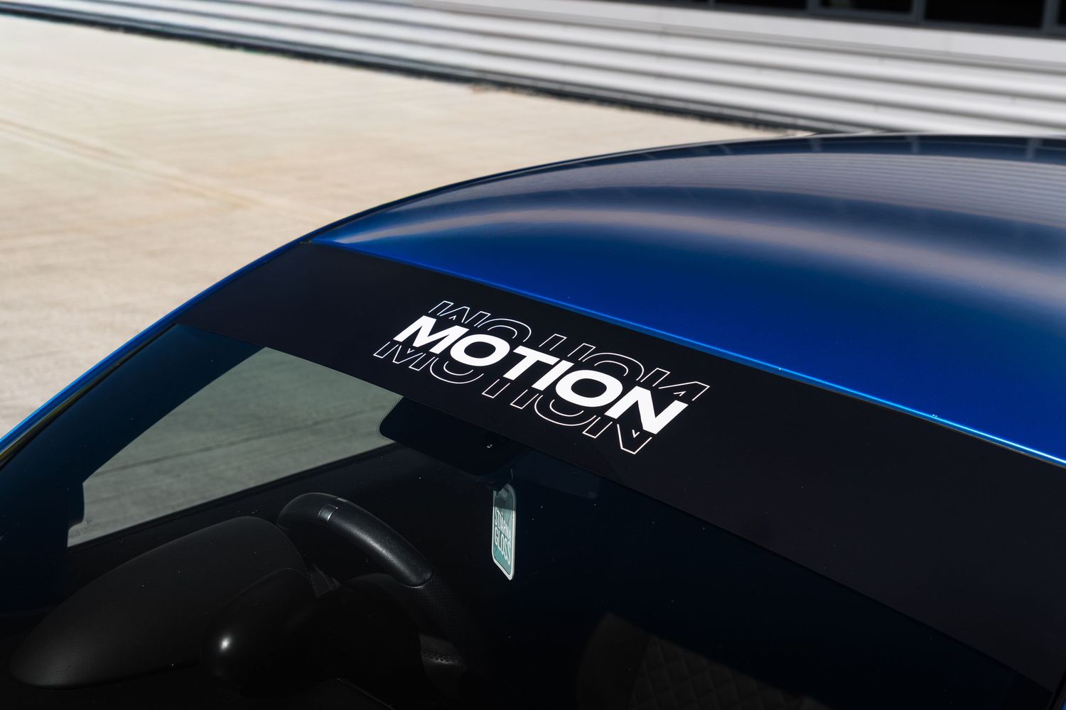 Close-up of Motion branding decal on the roofline of a blue Abarth 500.