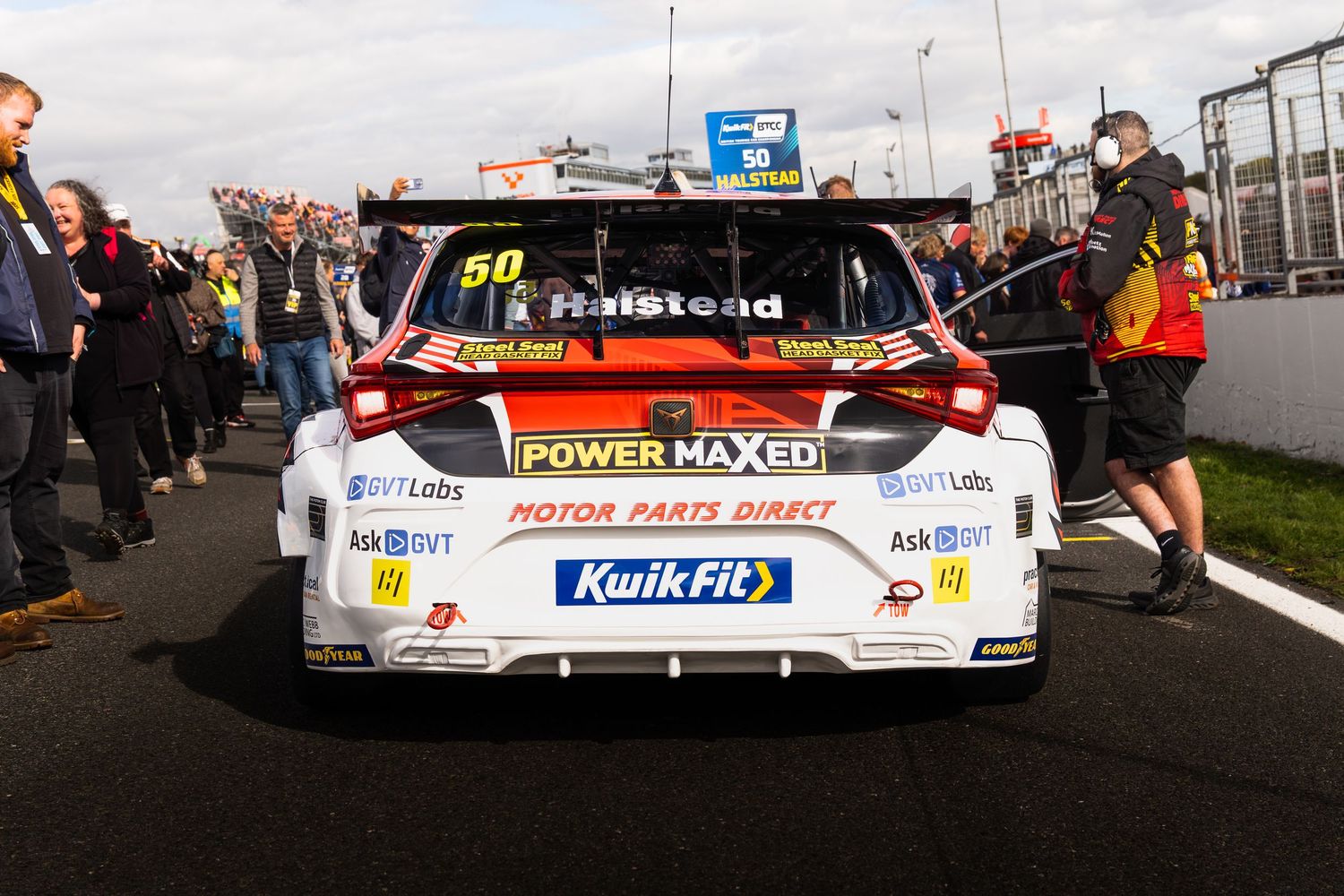 Power Maxed BTCC car number 50 driven by Halstead on starting grid at motorsport event.
