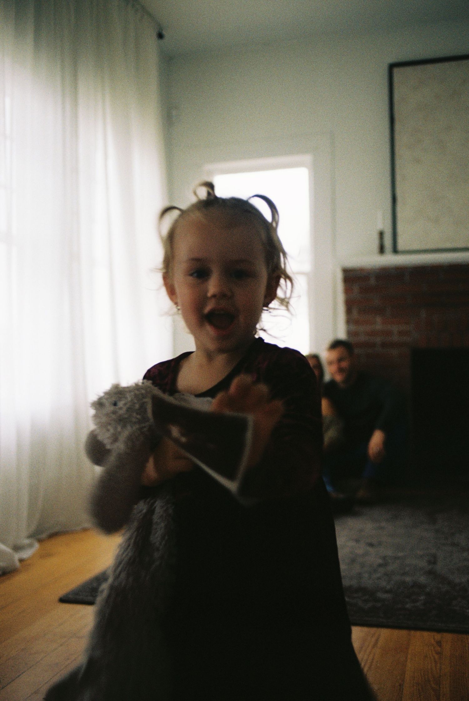 A sequence of playful moments showing a small child with a stuffed toy cat in a home setting.