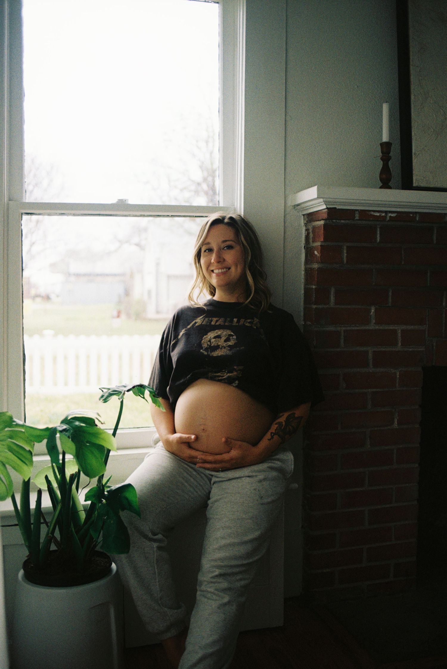 A sequence of maternity photos showing a pregnant person posing by a window with houseplants.