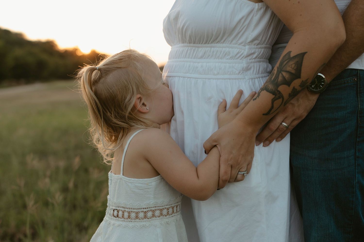 A series of intimate outdoor family moments captured at golden hour in a grassy field.