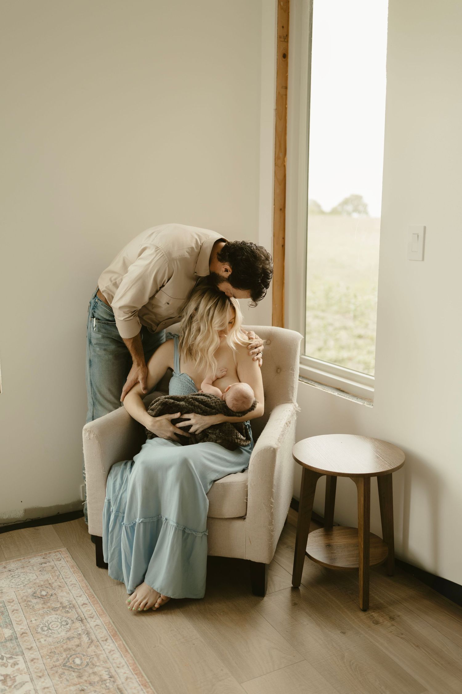 In-home newborn photo of family bonding with new baby in the nursery. Captured by Brittany Ruiz Photography in the Georgetown, TX area.