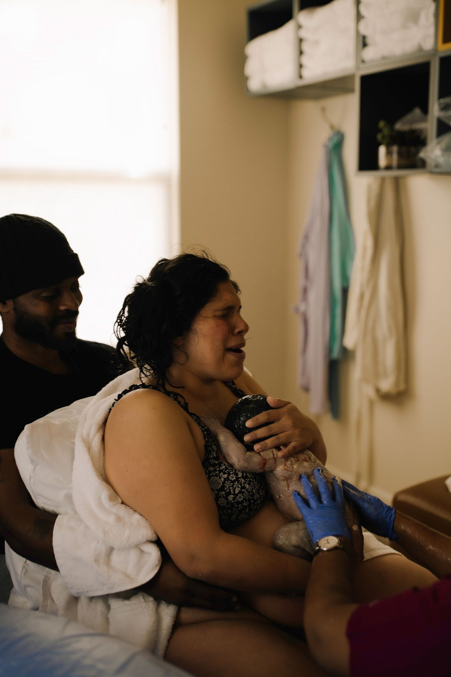Emotional birth moment showing a mother holding her baby right after delivery.