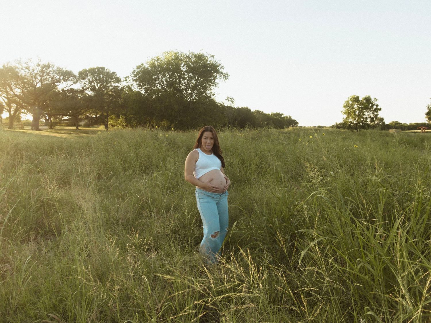 A series of images showing people strolling through a tall grass meadow during golden hour at sunset.