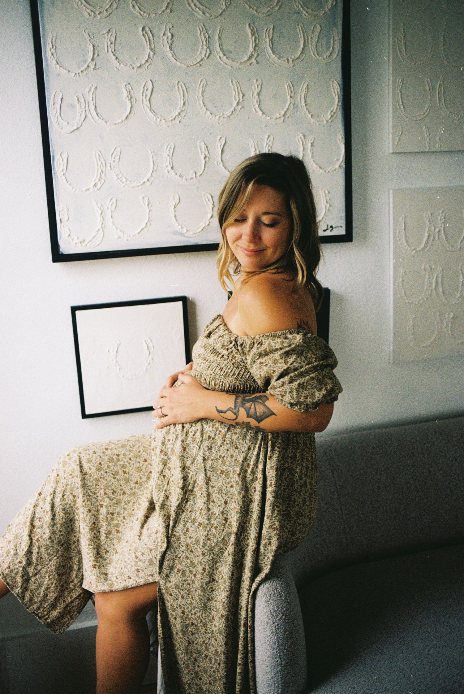 A series of photos showing someone in a floral dress against a white wall with framed artwork.