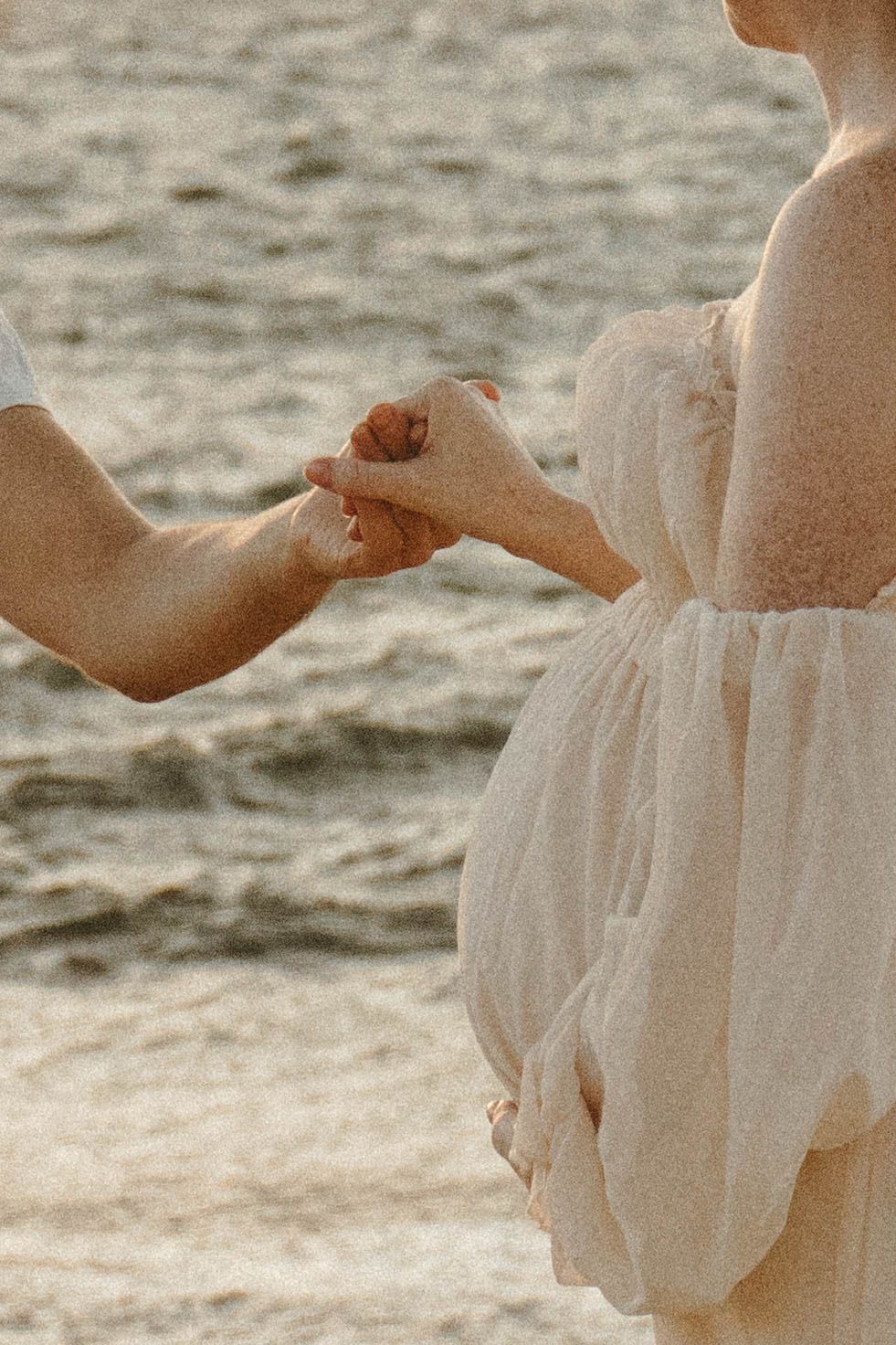 Pregnant lady holding hand.