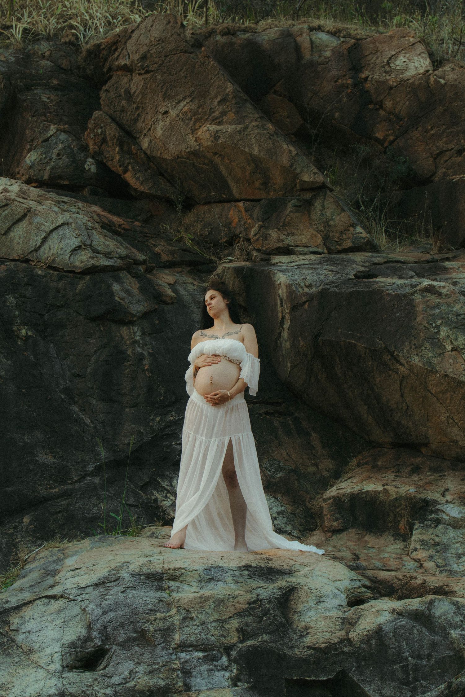 Pregnant woman on rocks