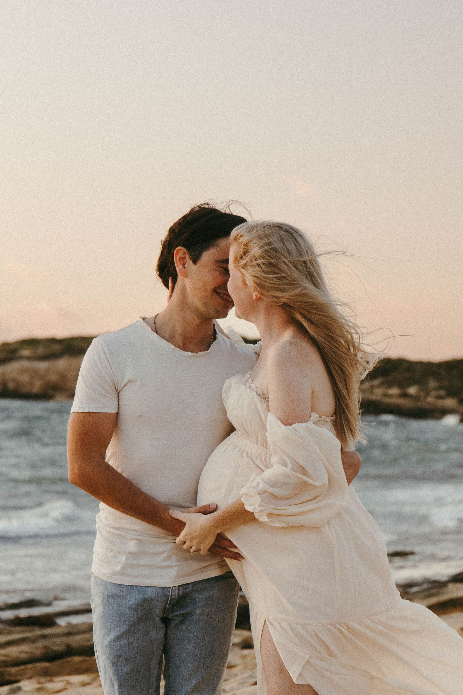 Pregnant woman kissing partner