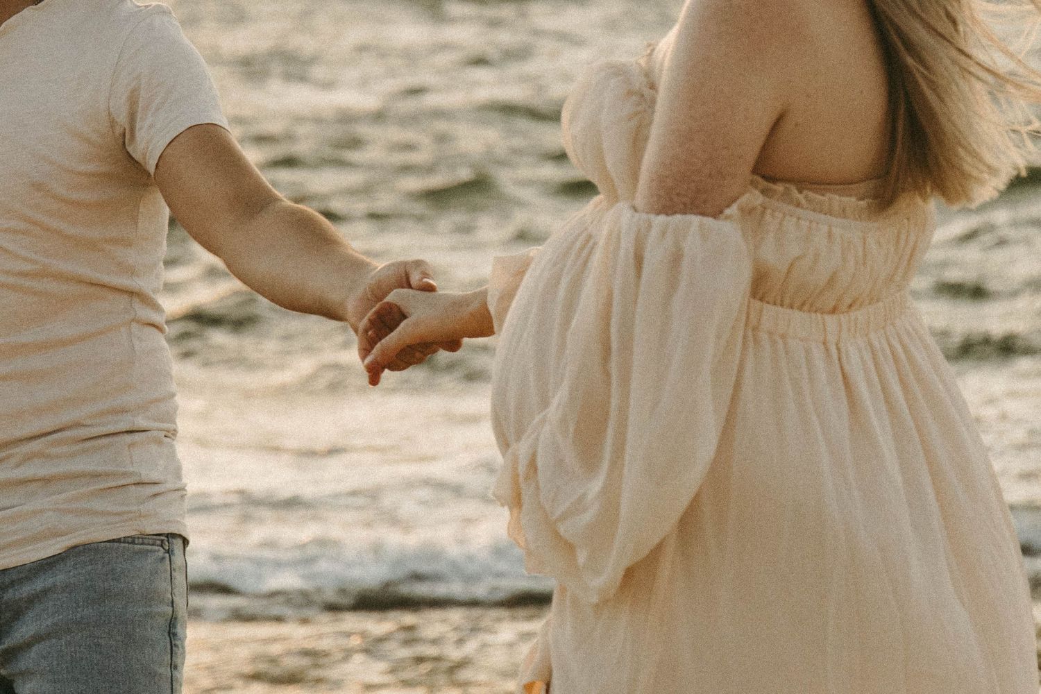 Pregnant woman holding hand