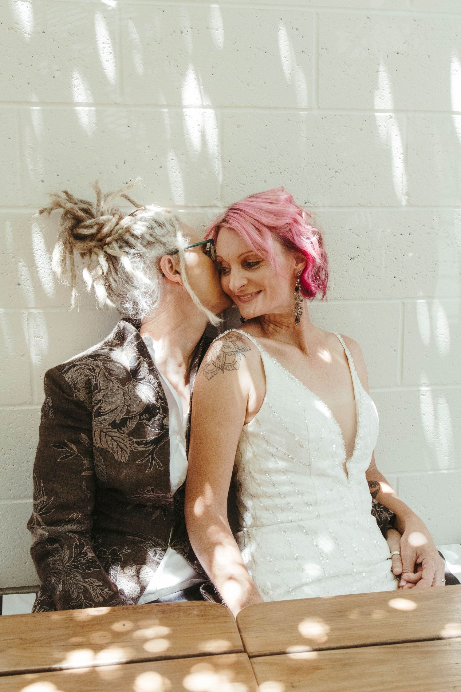 Happy couple in dappled lighting.