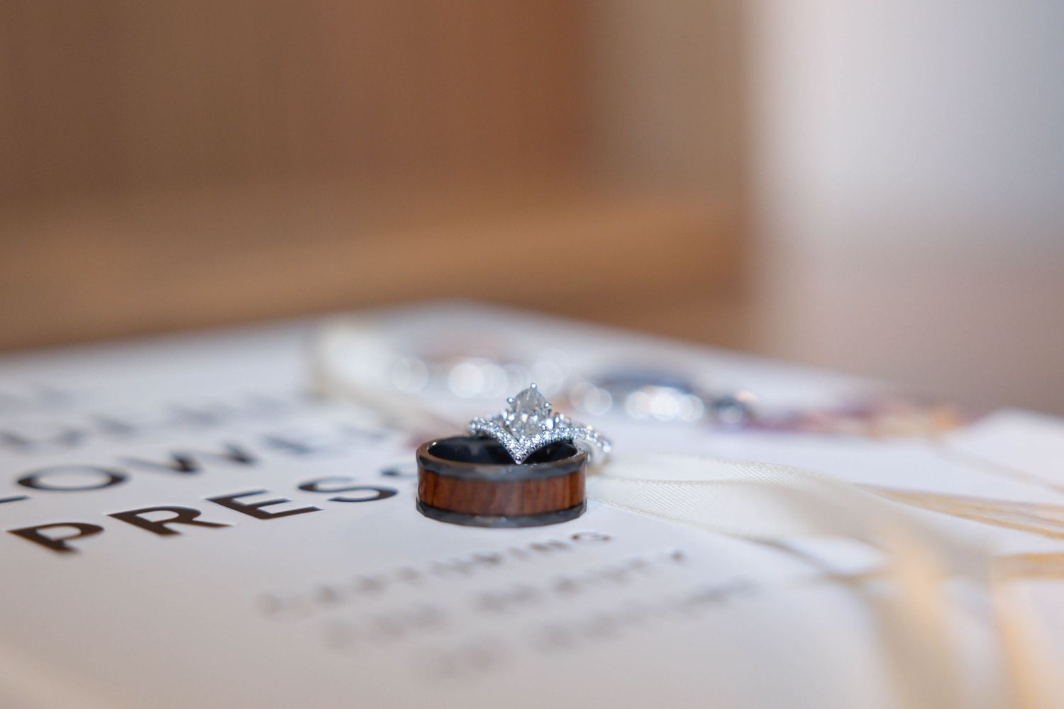 wedding rings on top of a flower press book.