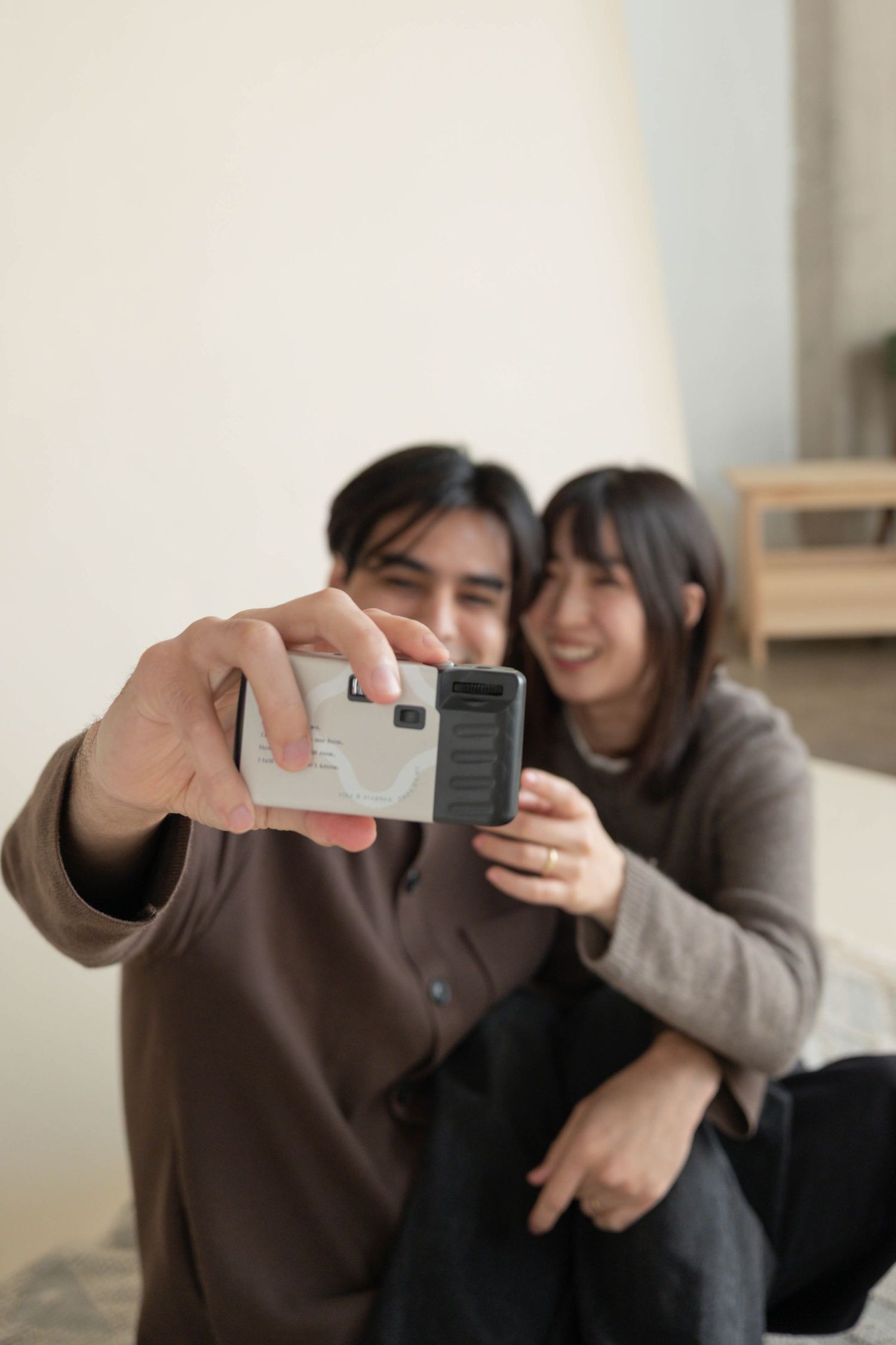 couple taking a selfie with film camera.