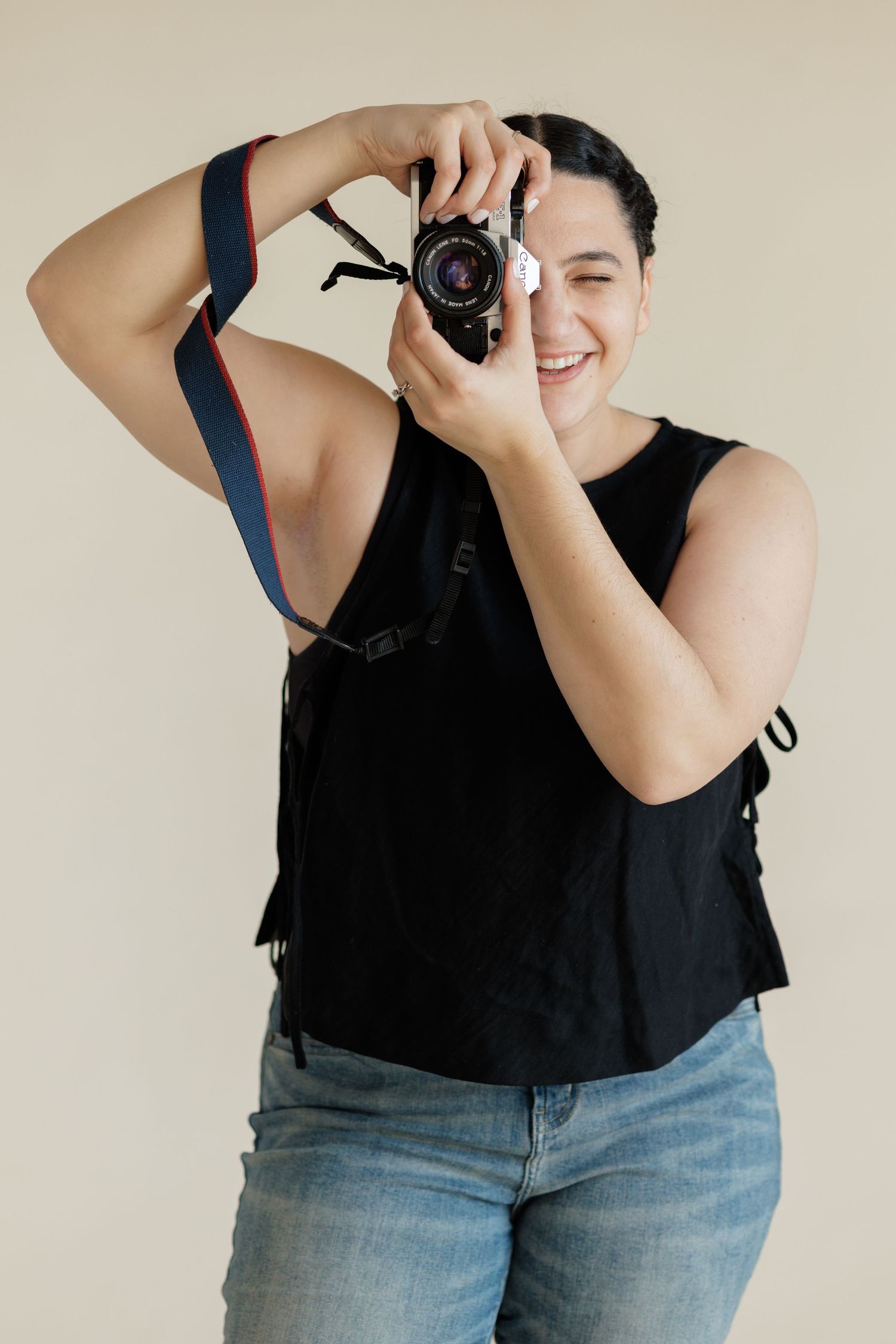 photographer looking through film camera