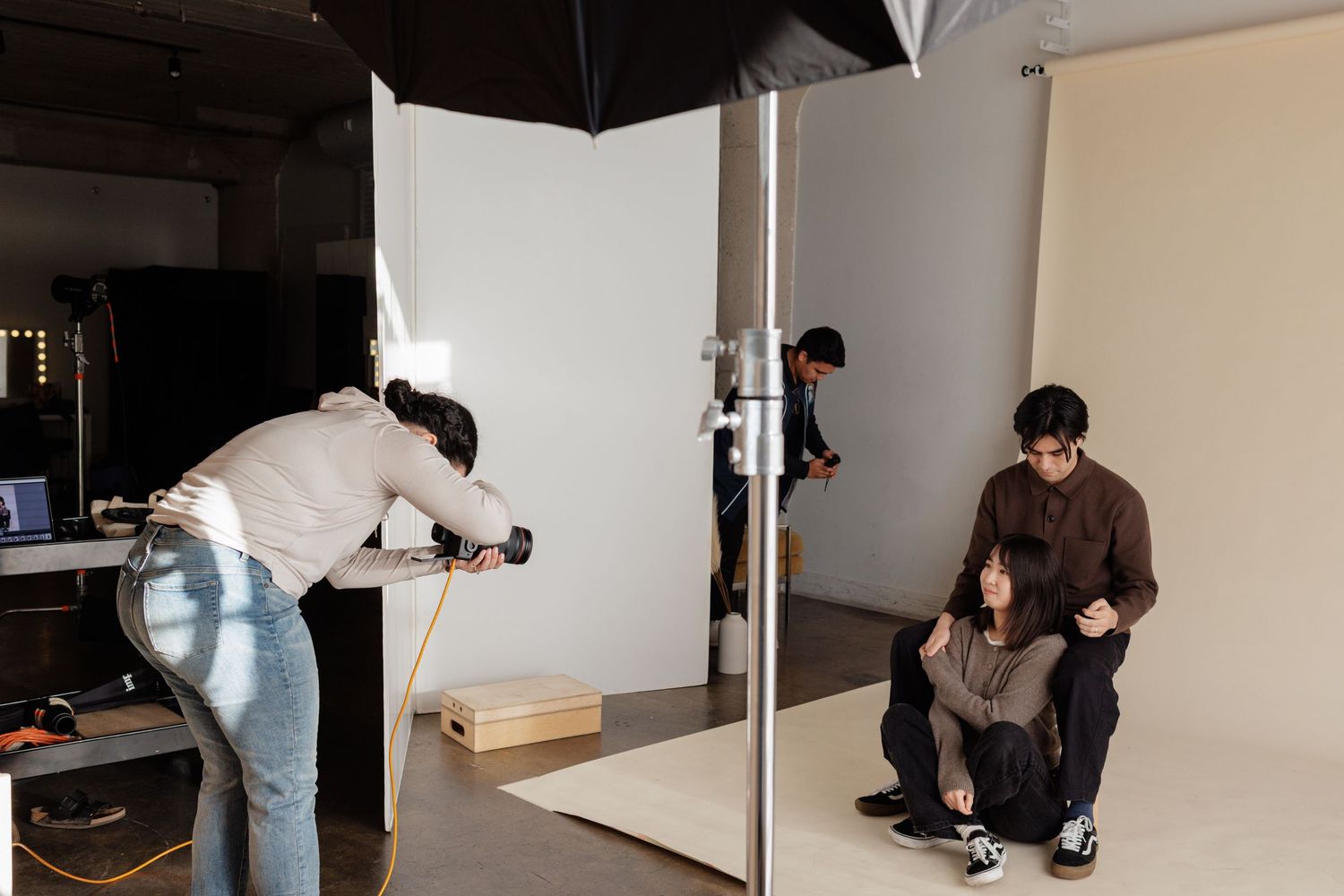 photo of photo team at work capturing images of models in a studio.