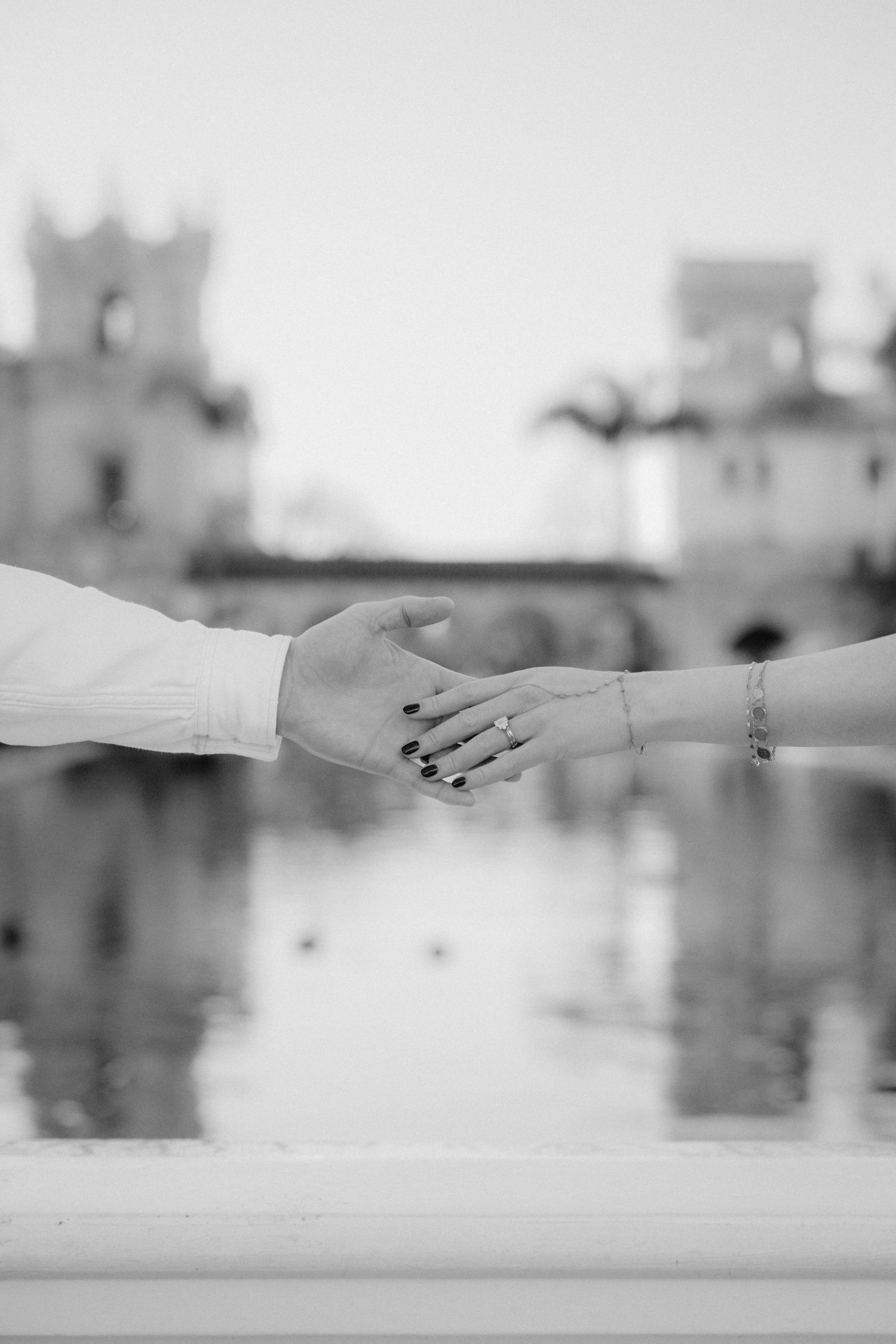 close up of hands holding with balboa in the background.