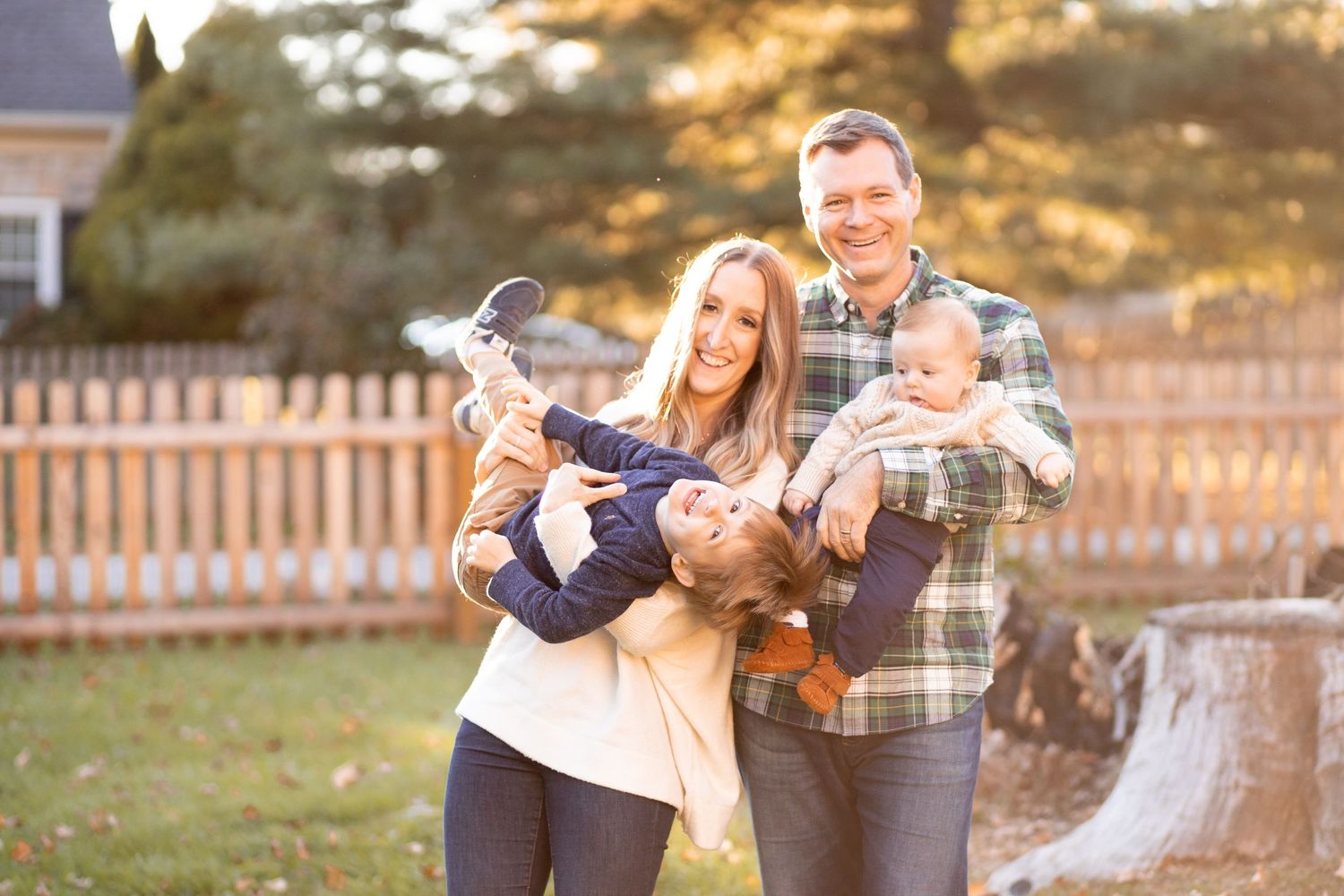A happy couple embraces outdoors while enjoying a sunny autumn afternoon together.