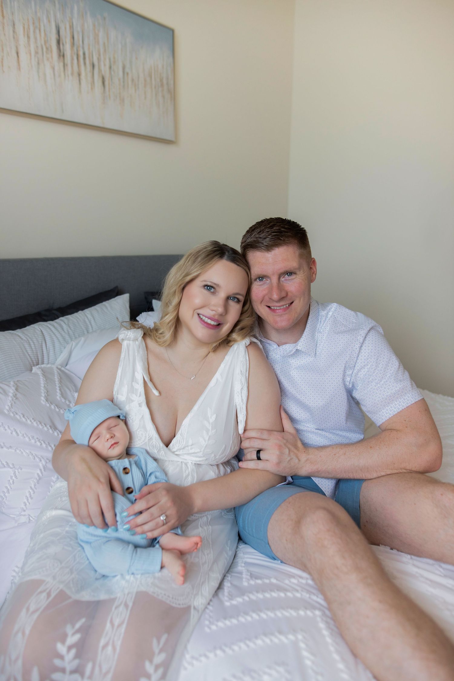 A couple relaxes together on white bedding while sharing intimate moments in a series of connected photos.