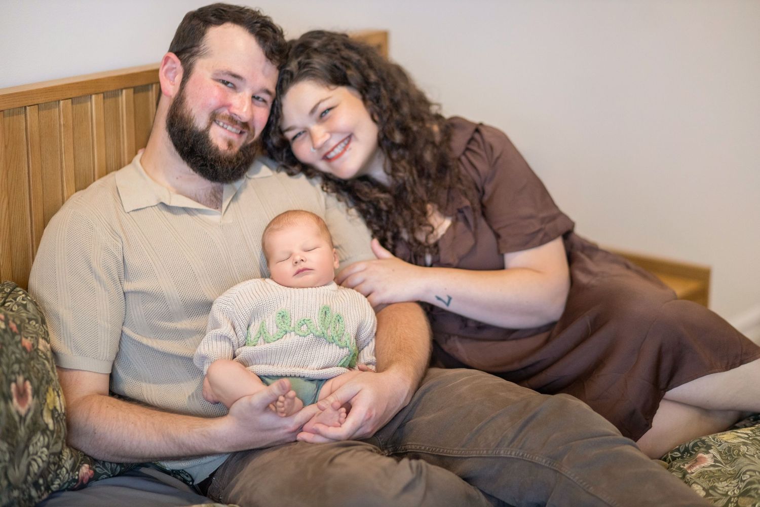 A series of five candid photos showing tender moments between a couple and their newborn baby at home.