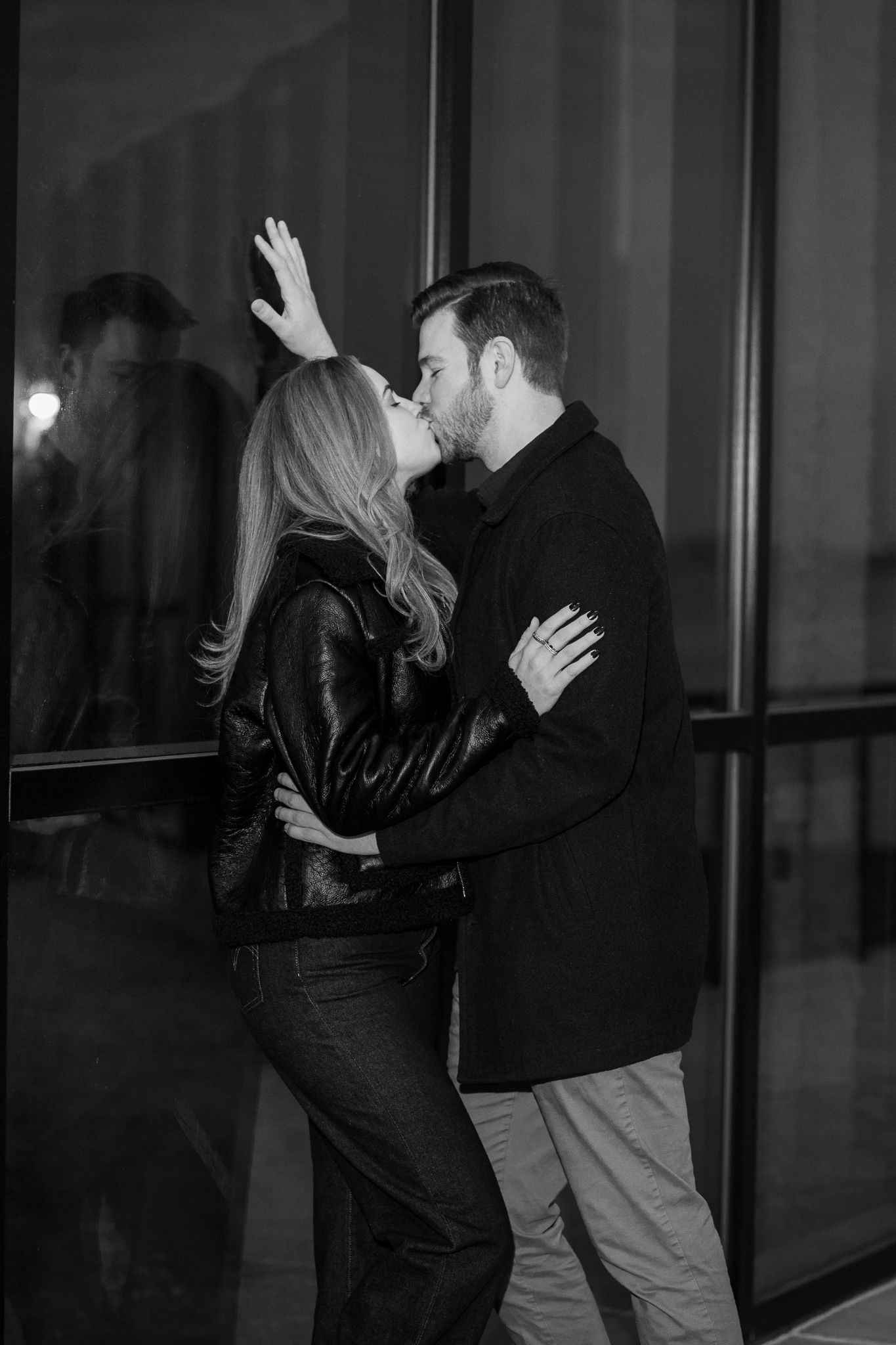 A couple in black and grey clothing dances together in a romantic sequence of progressive dance moves.