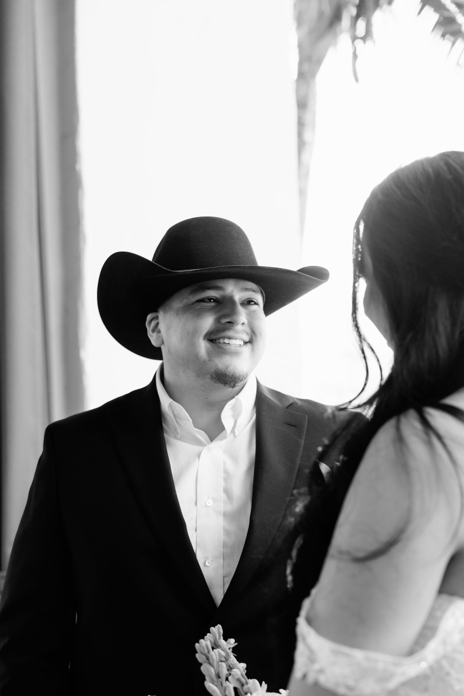 Black and white close-up portrait of a couple at their wedding.