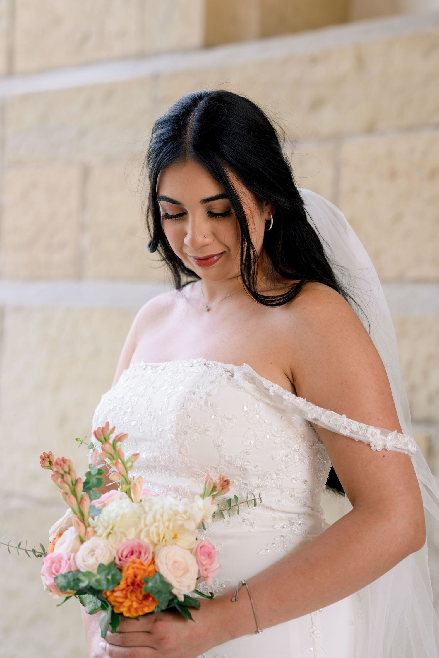 Close-up shots of a bride in a lace off-shoulder gown holding a colorful bouquet.