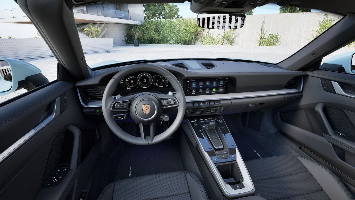 Interior dashboard view of Porsche 911 displaying modern digital controls and luxurious cockpit design.