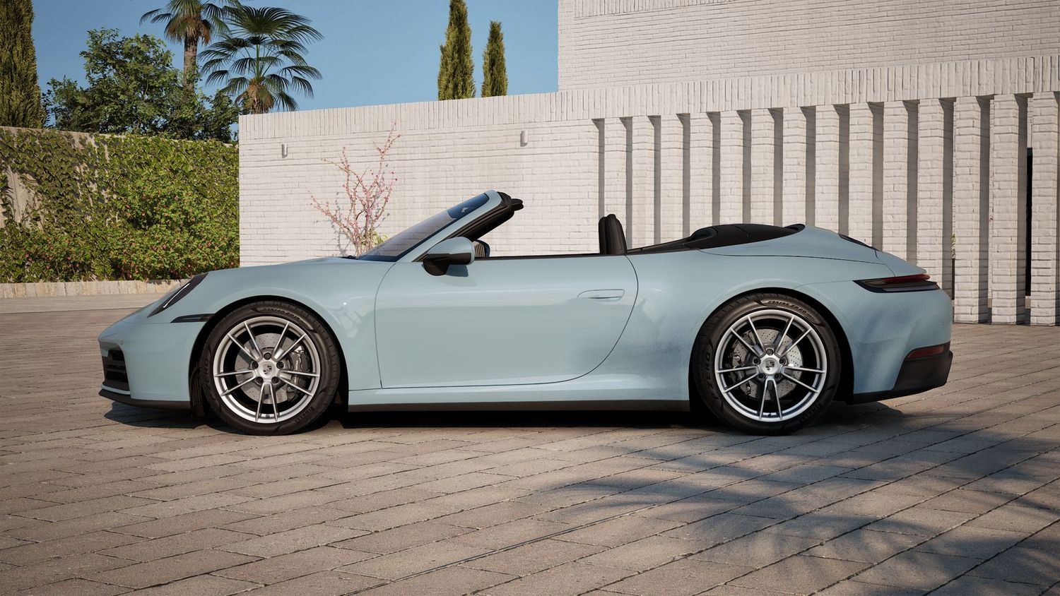 Light blue Porsche 911 luxury sports car photographed from multiple angles against architectural backdrop.