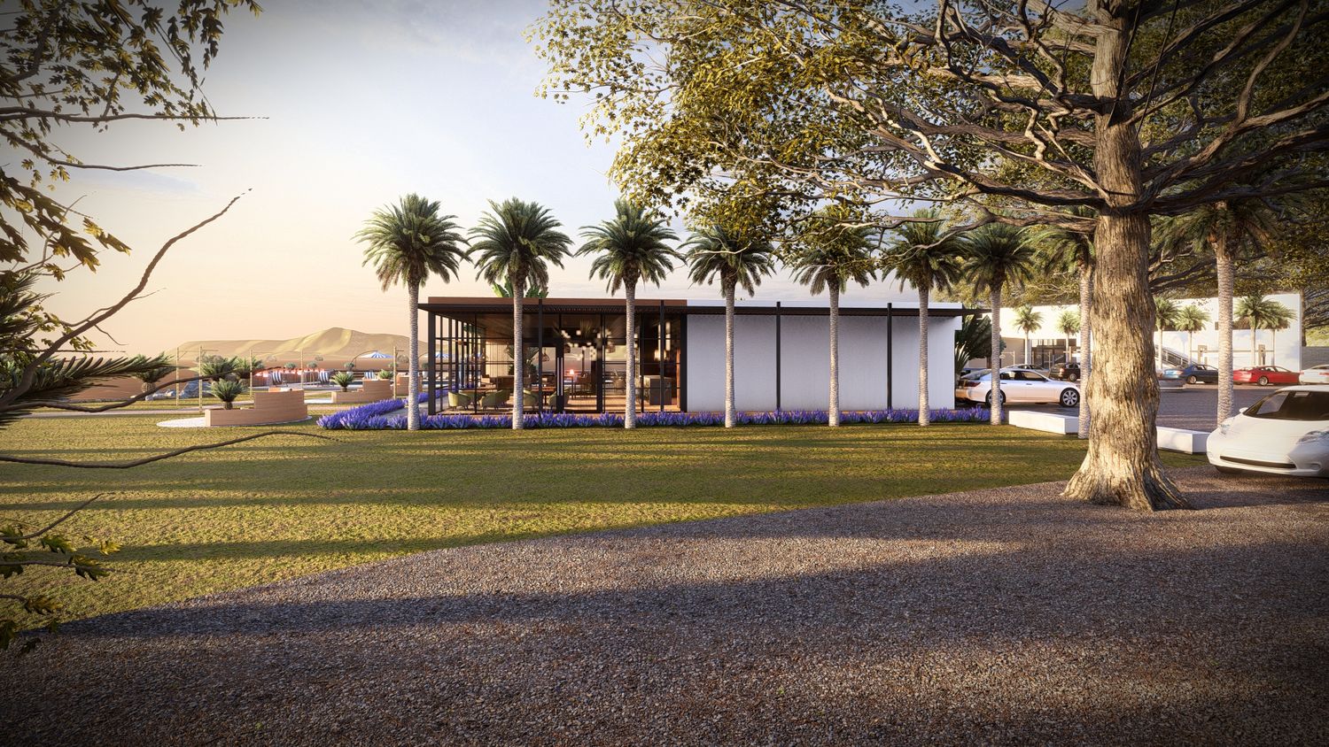Landscaped exterior view of a modern commercial building with trees and paved pathways.