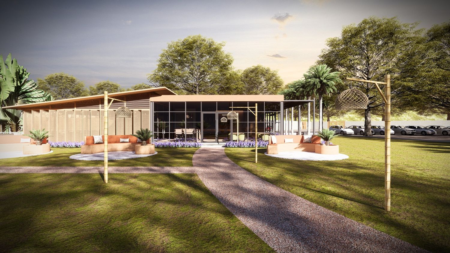 Modern building exterior with landscaped grounds and walking paths at sunset.