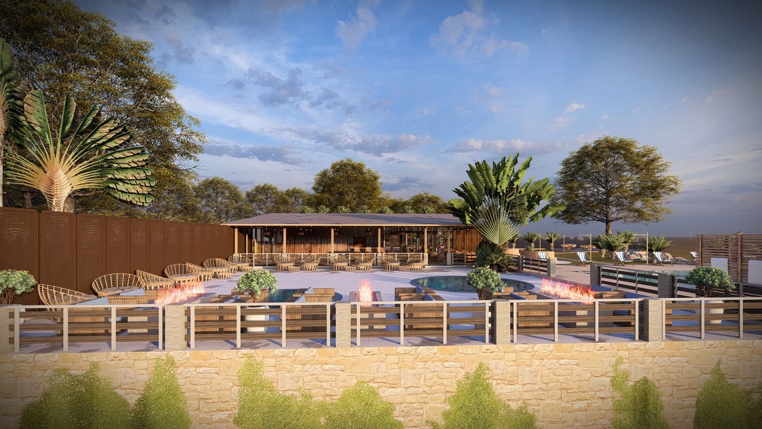 Modern commercial building exterior with stone wall features and landscaped grounds under blue sky.