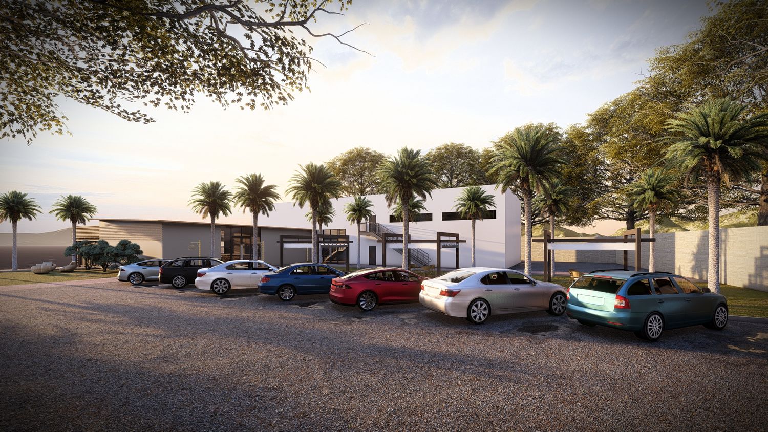 Modern commercial building exterior with parking lot and palm trees at dusk.