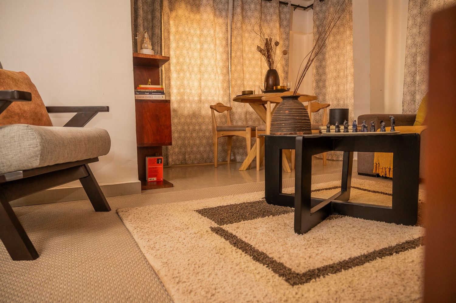 Minimalist living room with modern coffee table, plush seating, and warm ambient lighting.