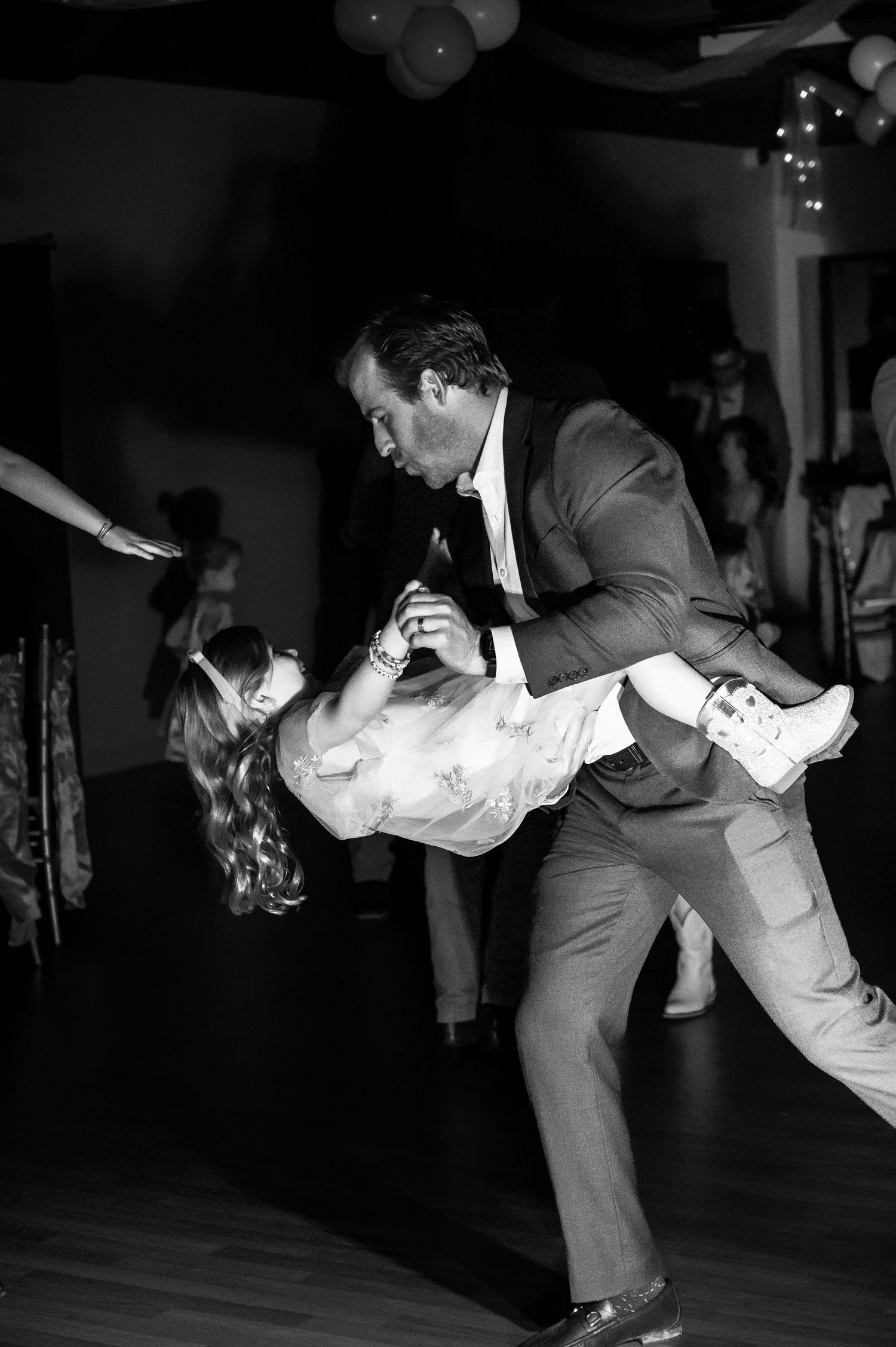 black and white photo of a father and daughter dancing