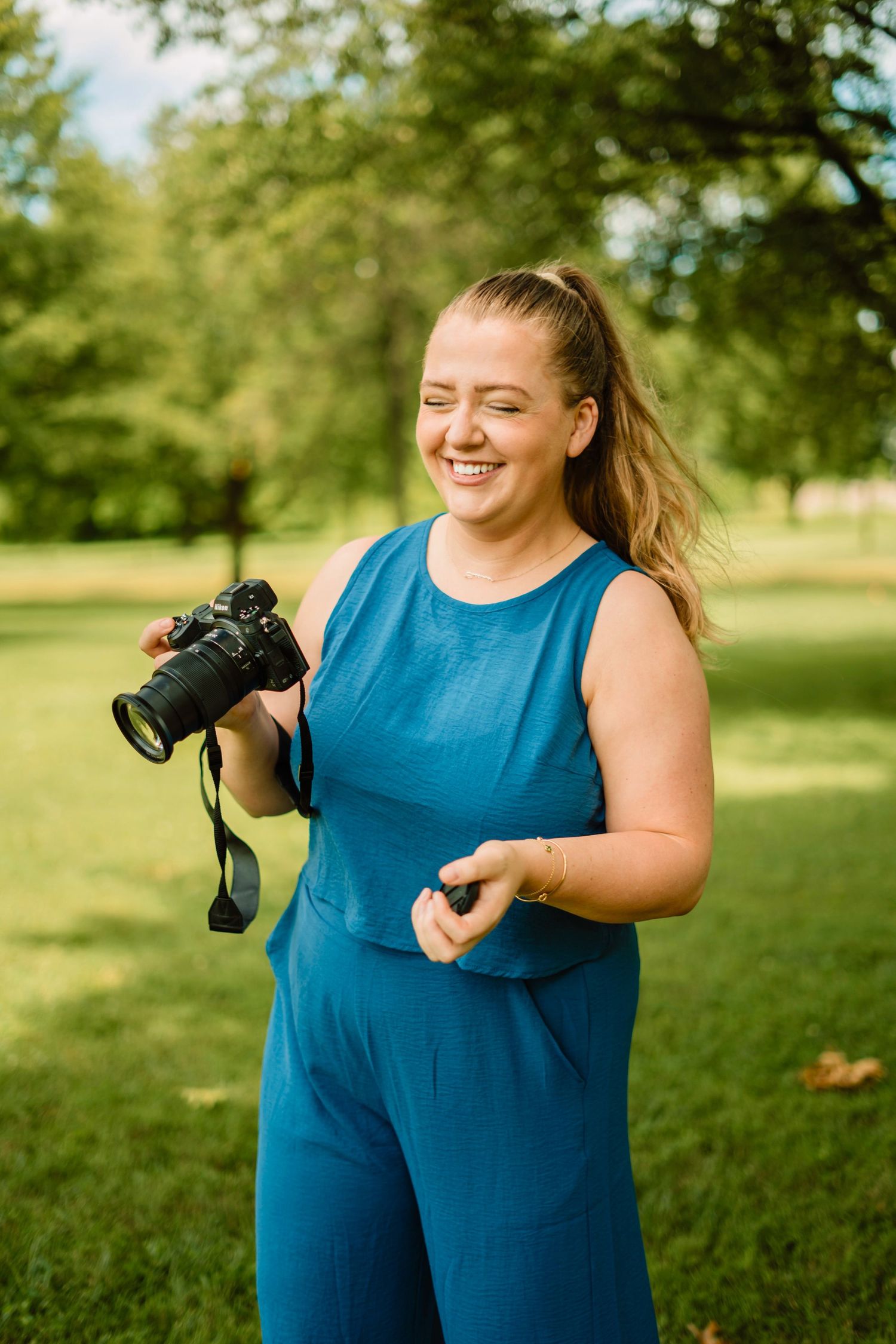 Taylor Burke, holding camera and smiling