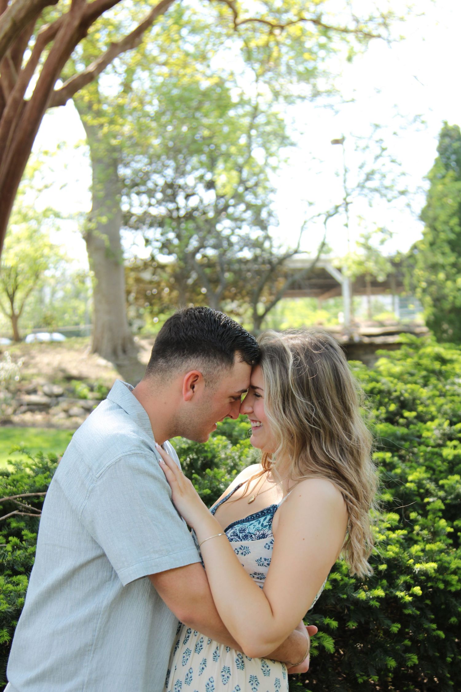 A tender moment between a couple in spring garden setting.