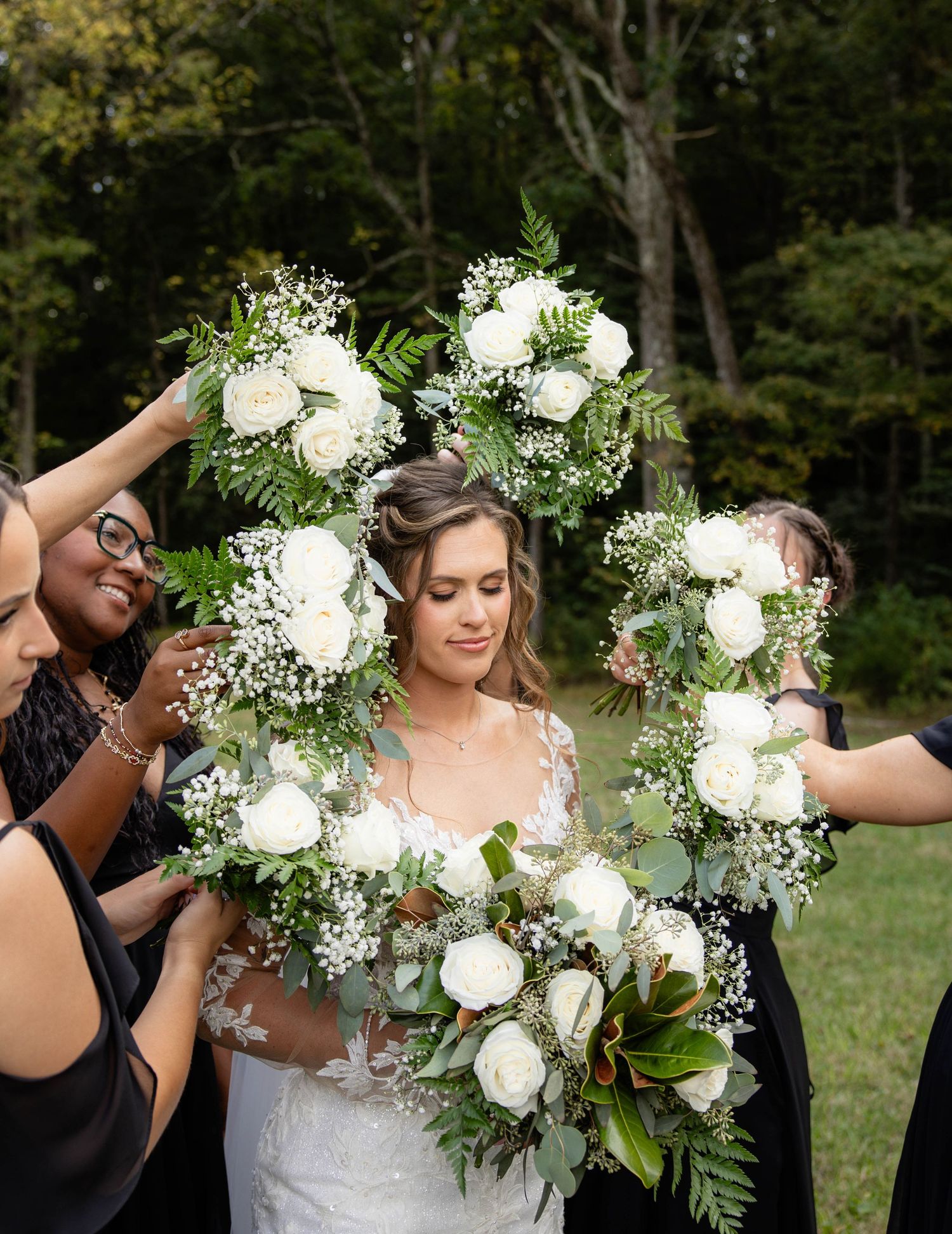 Close-up shots of a beautiful white rose and greenery wedding bouquet.
