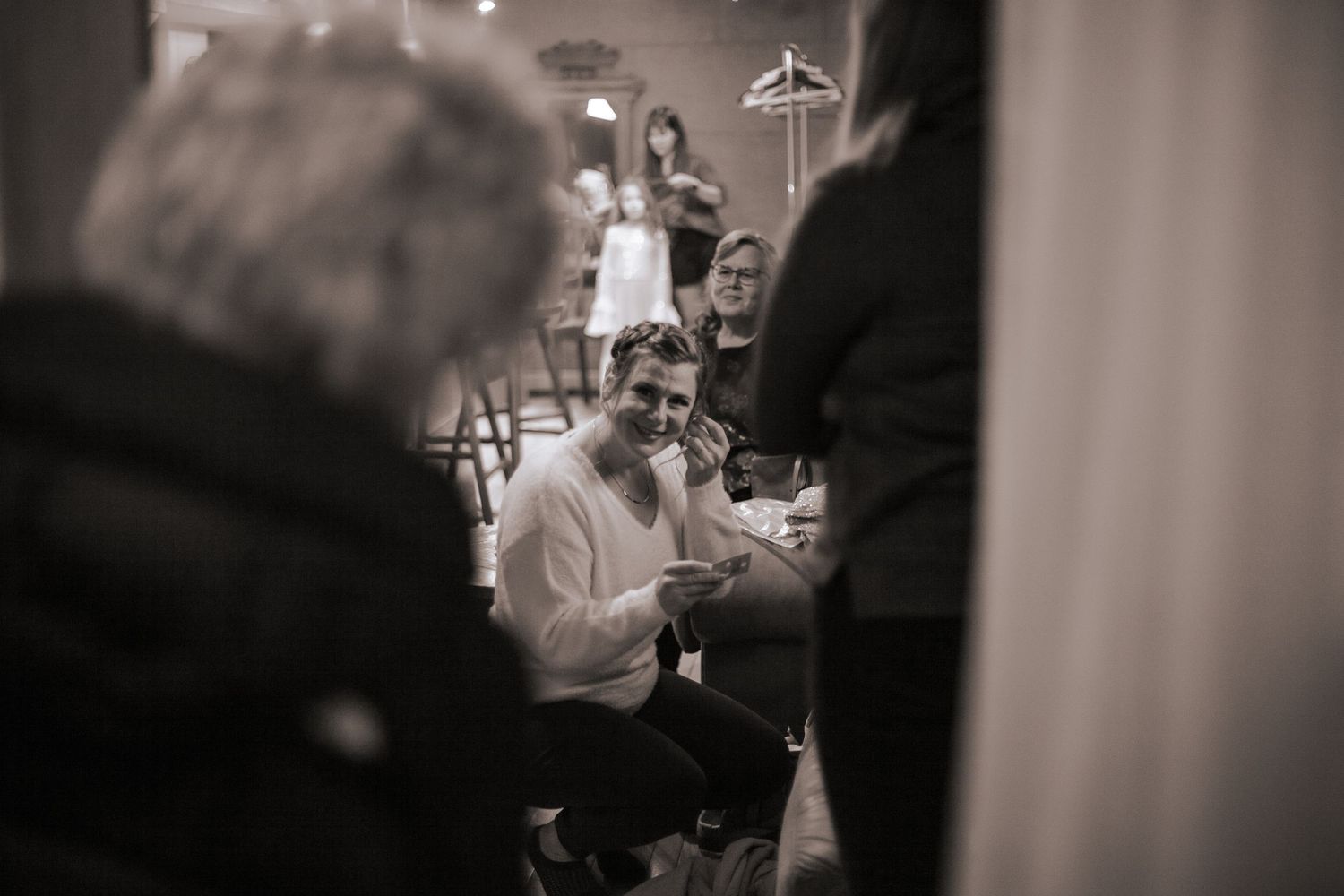 Bride to be getting ready while her mother and grandmother look on.