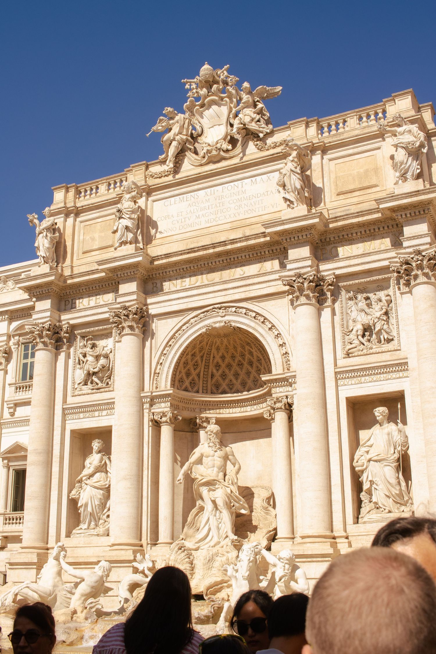 The Trevi Fountain at noon on a sunny day.
