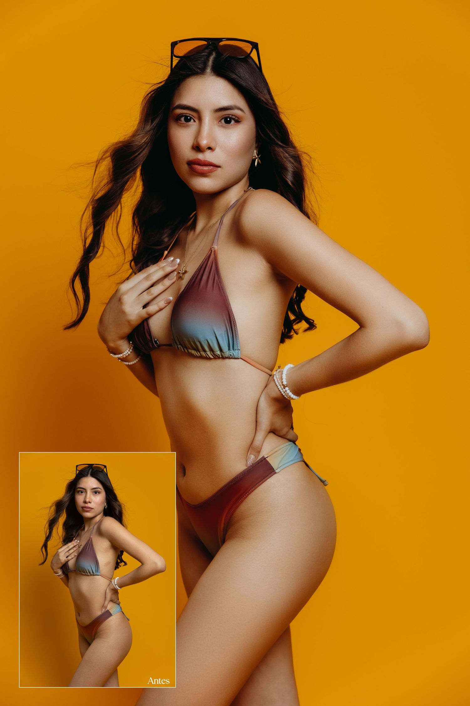 Fashion model poses against vibrant orange background in silver swimwear during professional photo session.