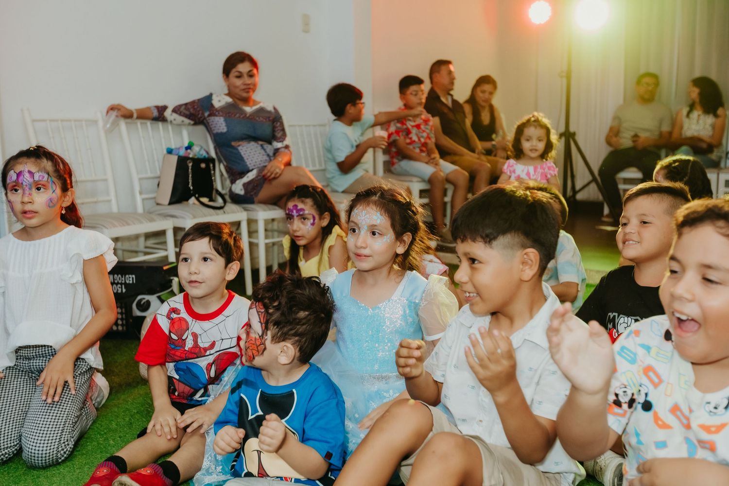 Group of children watching intently during a party performance.