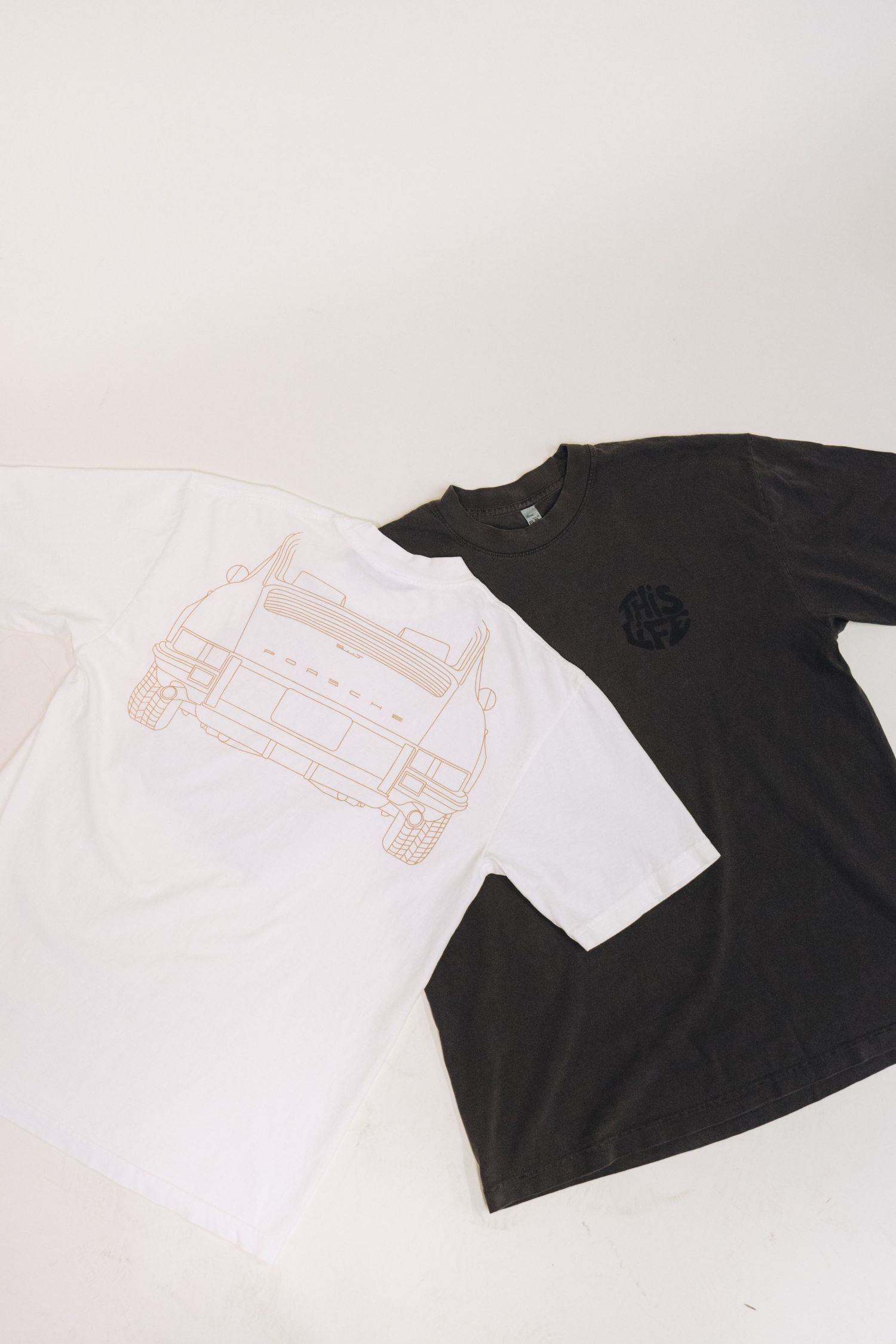 Black and white t-shirts with minimalist designs displayed side by side.