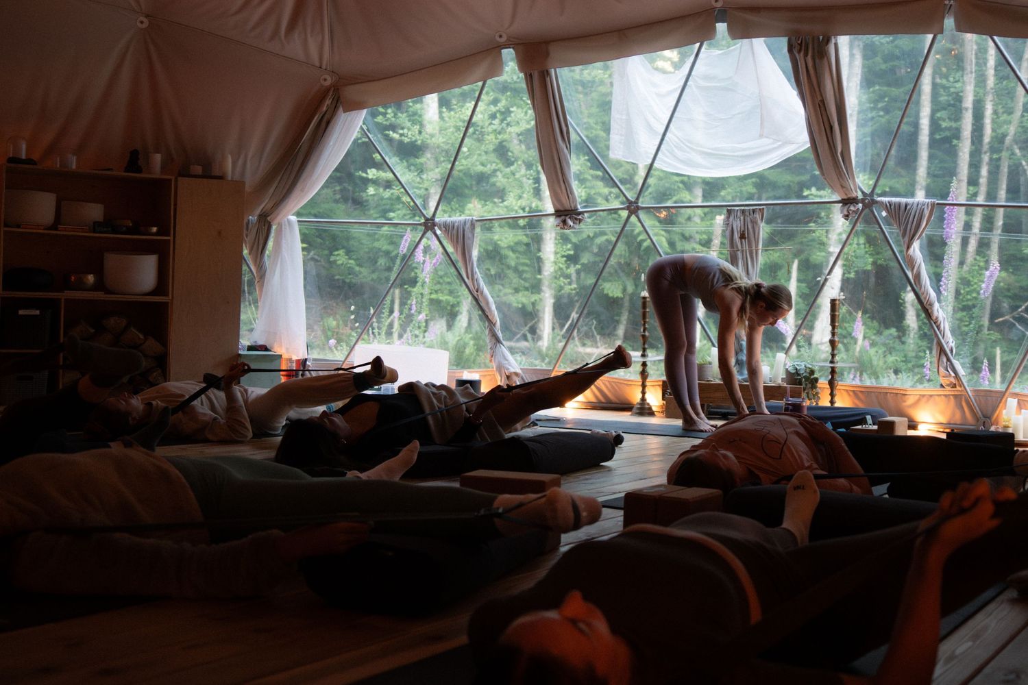 Interior view of a dome tent with cushions and natural light filtering through fabric walls.