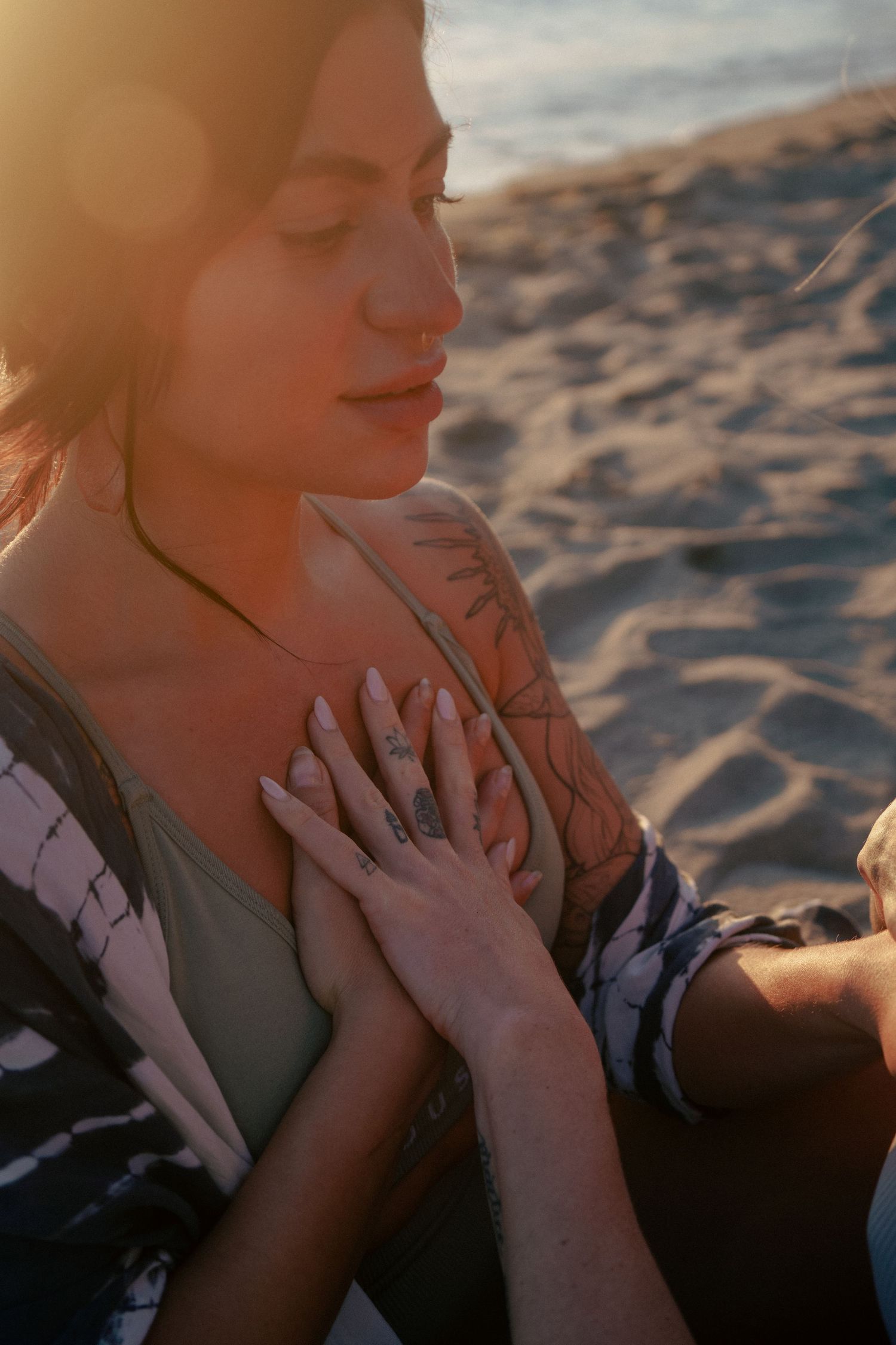 Intimate moment captured during golden hour on a sandy beach.