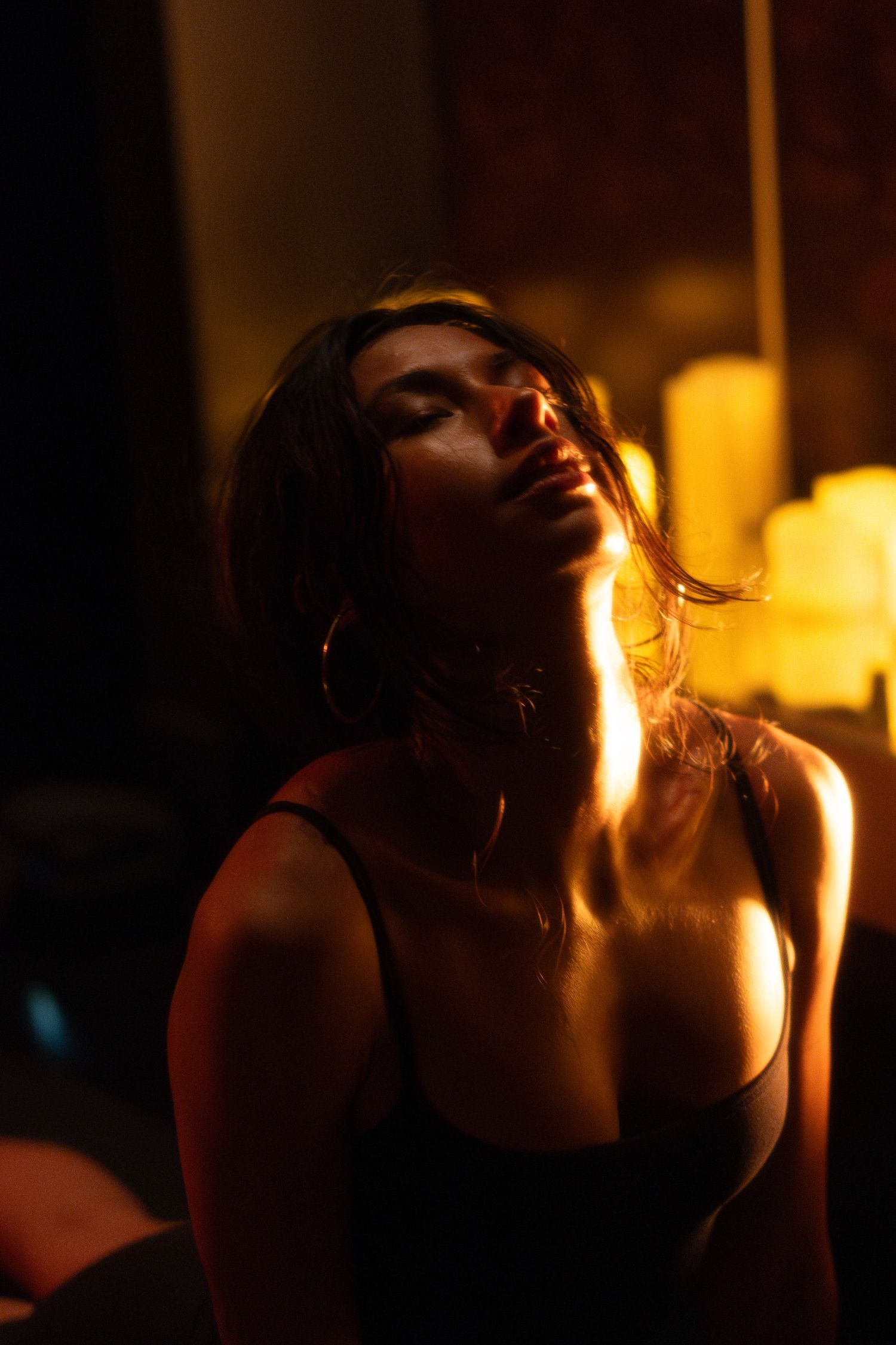 Atmospheric portrait in warm lighting capturing an intimate artistic moment.