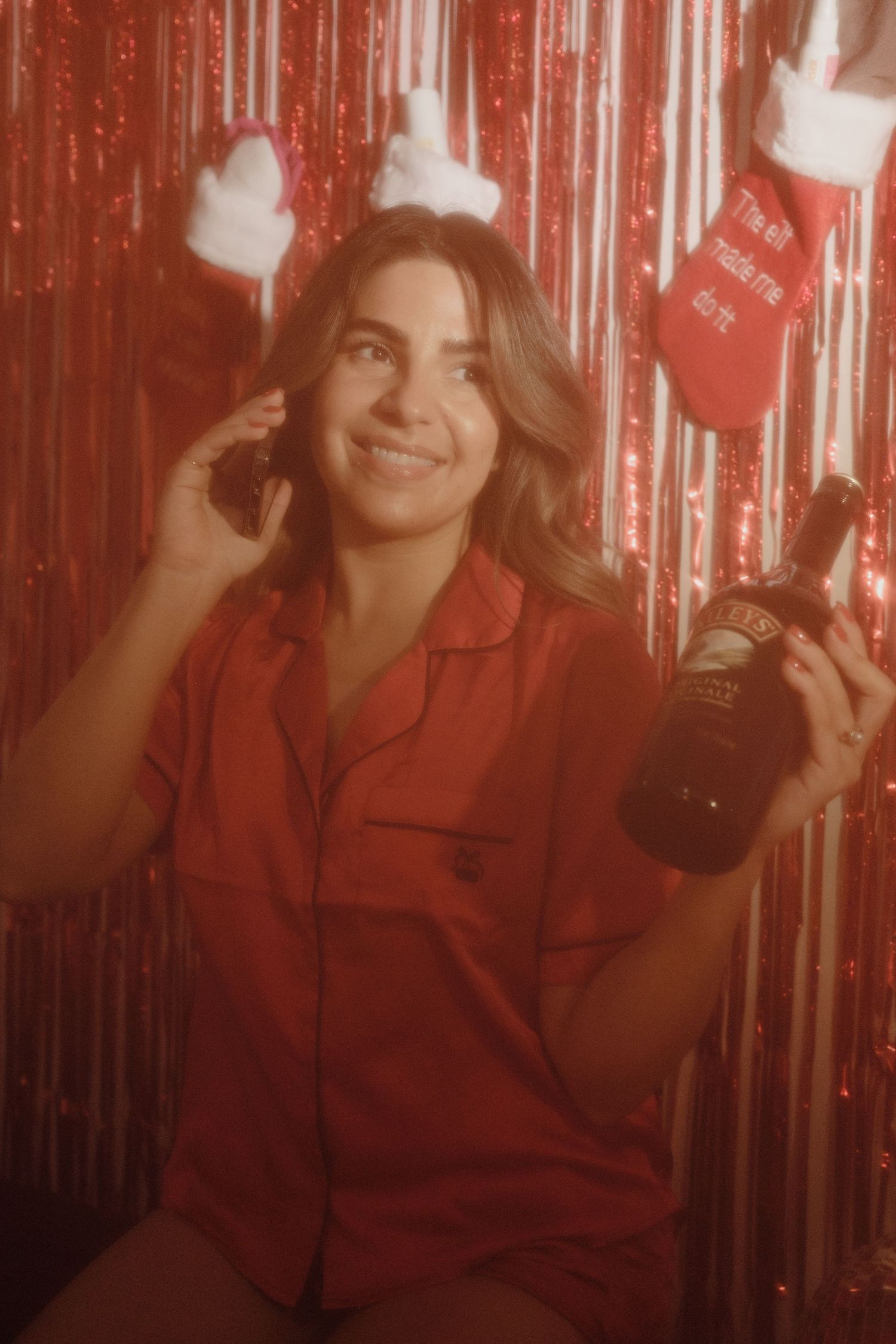 Festive celebration scene with red shirt and champagne against sparkly background.