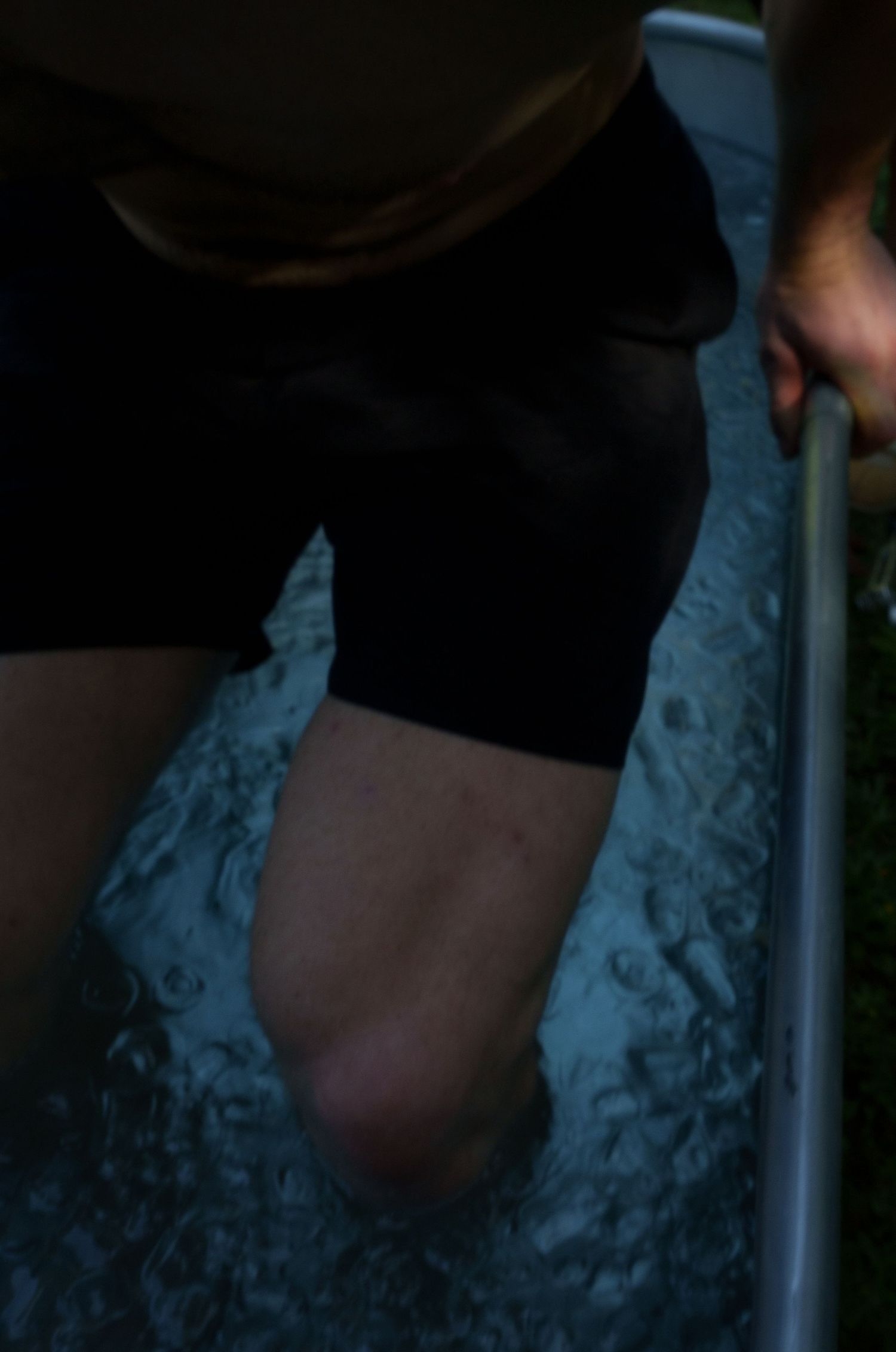 Close-up of dark water reflection with rippling surface texture.