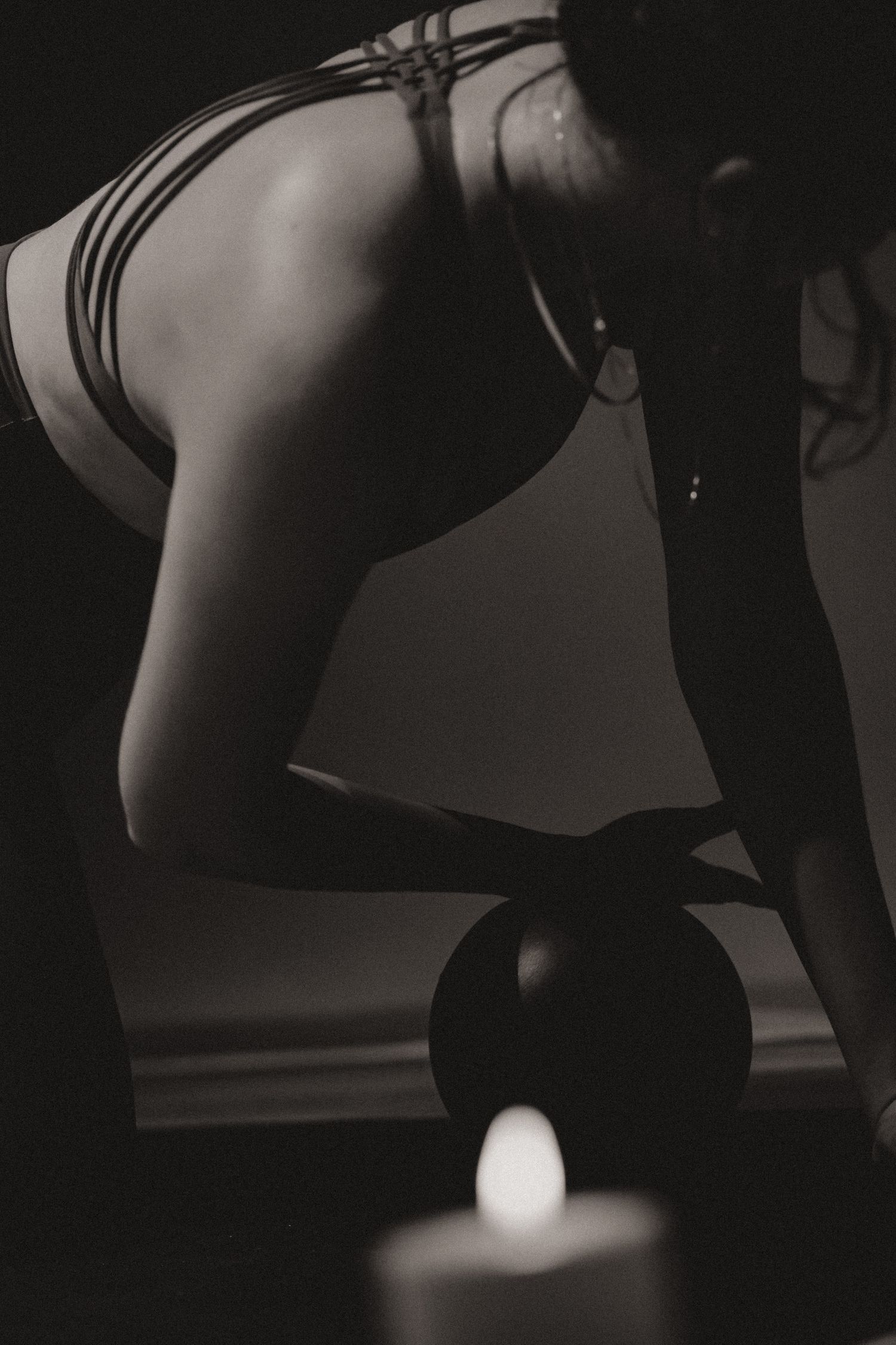 Artistic black and white photo of yoga practice with meditation candle.